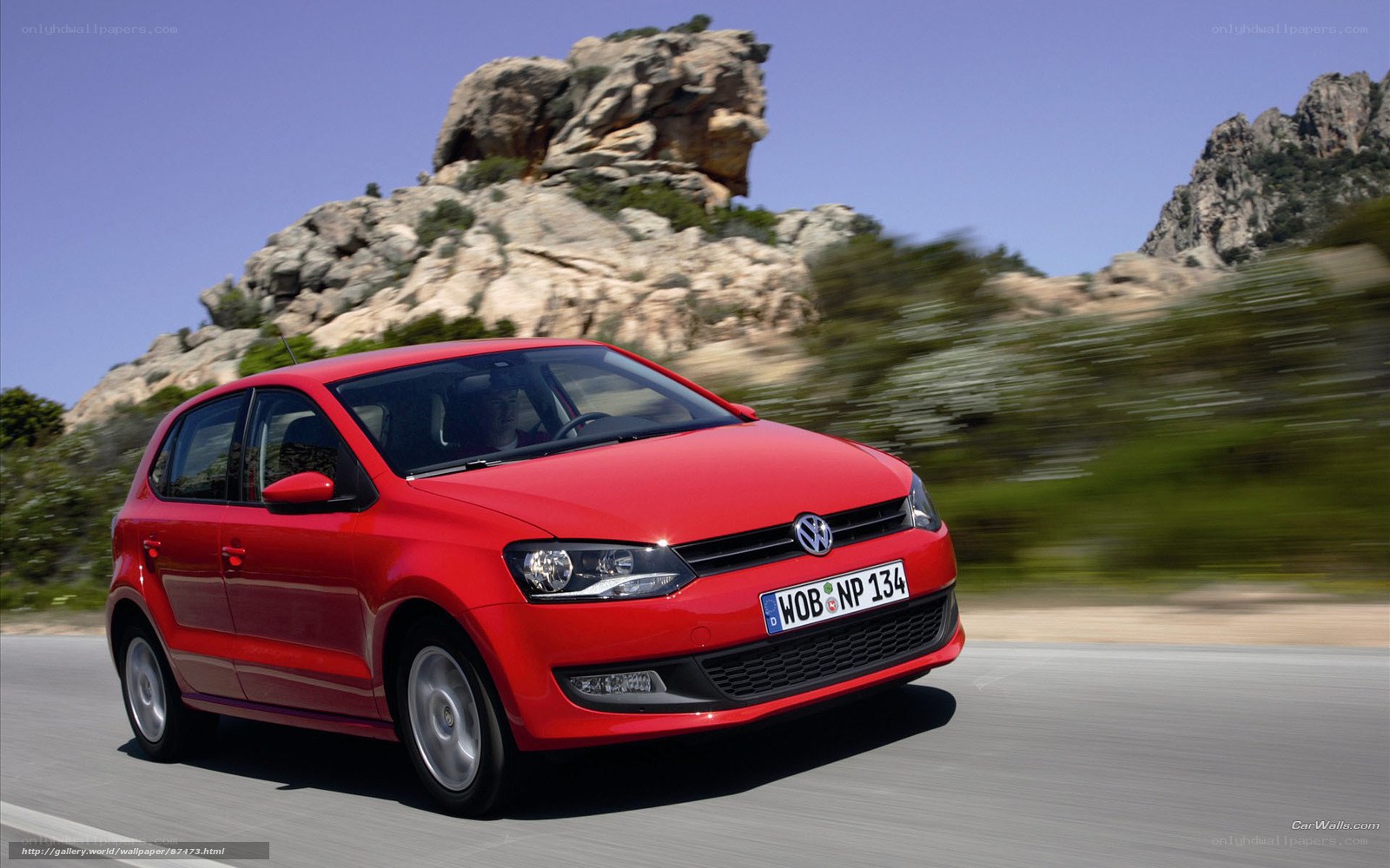 Red Volkswagen Polo in motion