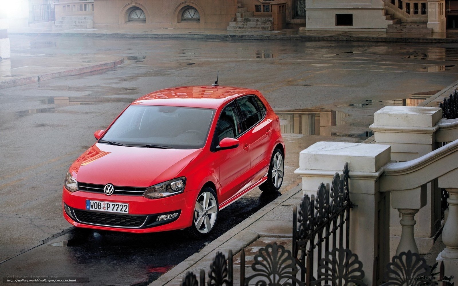 Red Volkswagen Polo on wet street