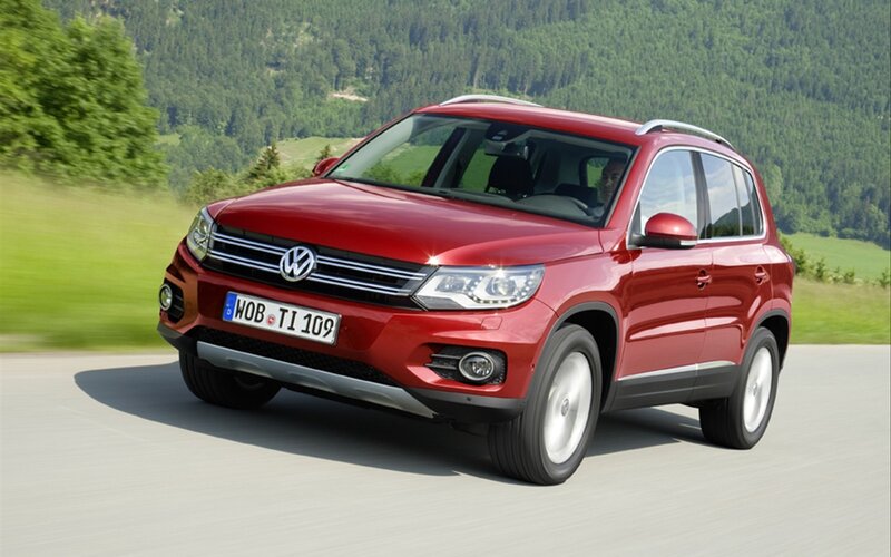 Red Volkswagen Tiguan on a road