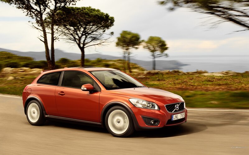 red volvo c30 driving on coastal road