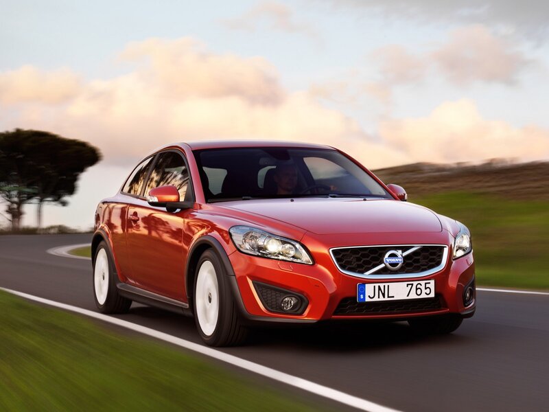 Red Volvo C30 driving on road