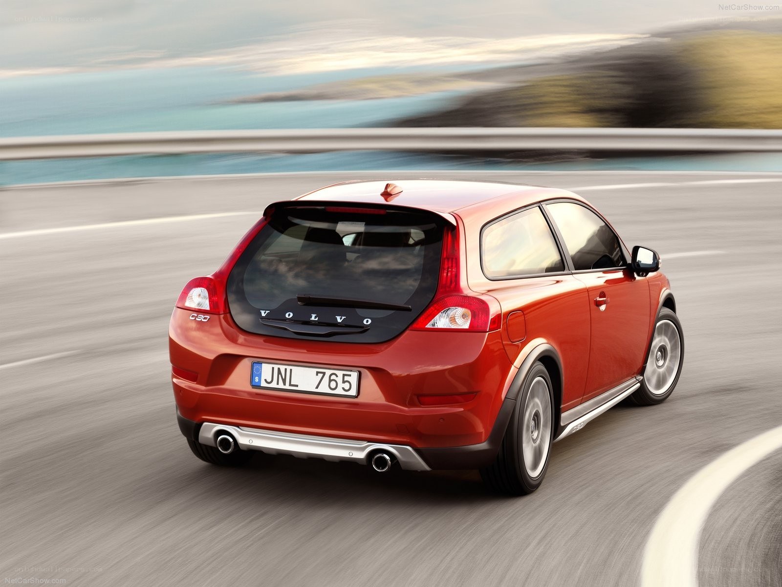 Red Volvo C30 in motion