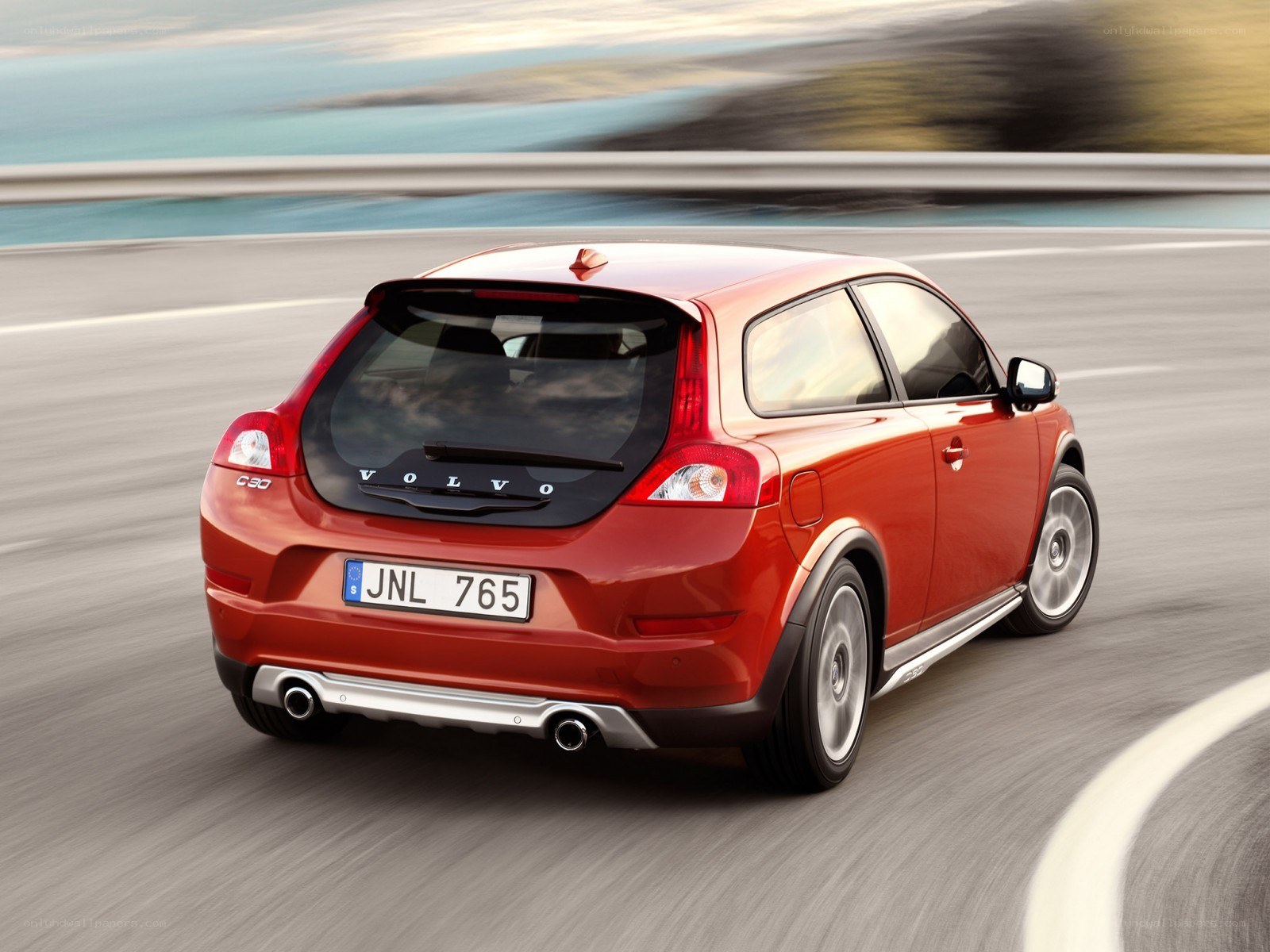 Red Volvo C30 in motion