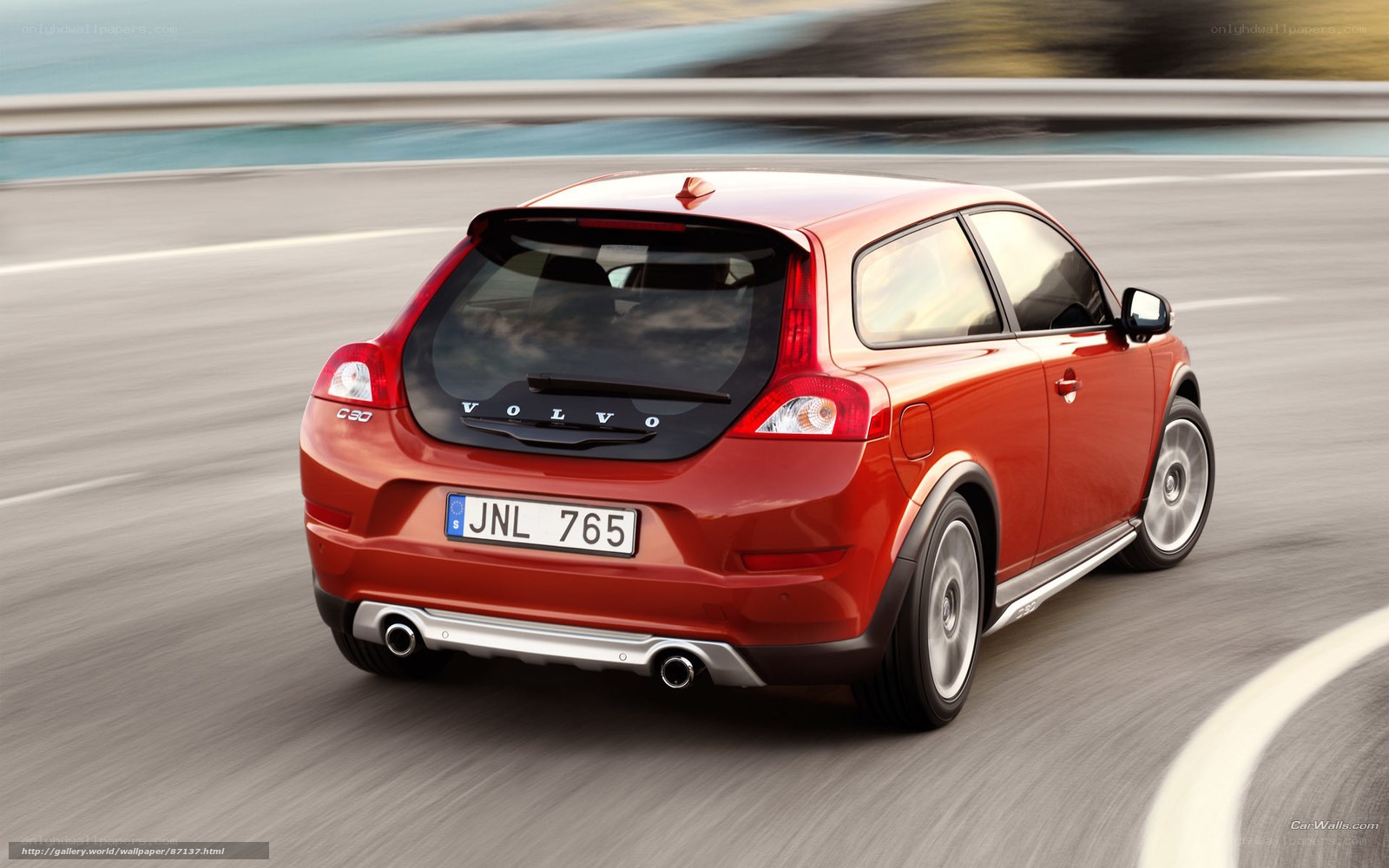 Red Volvo C30 in motion