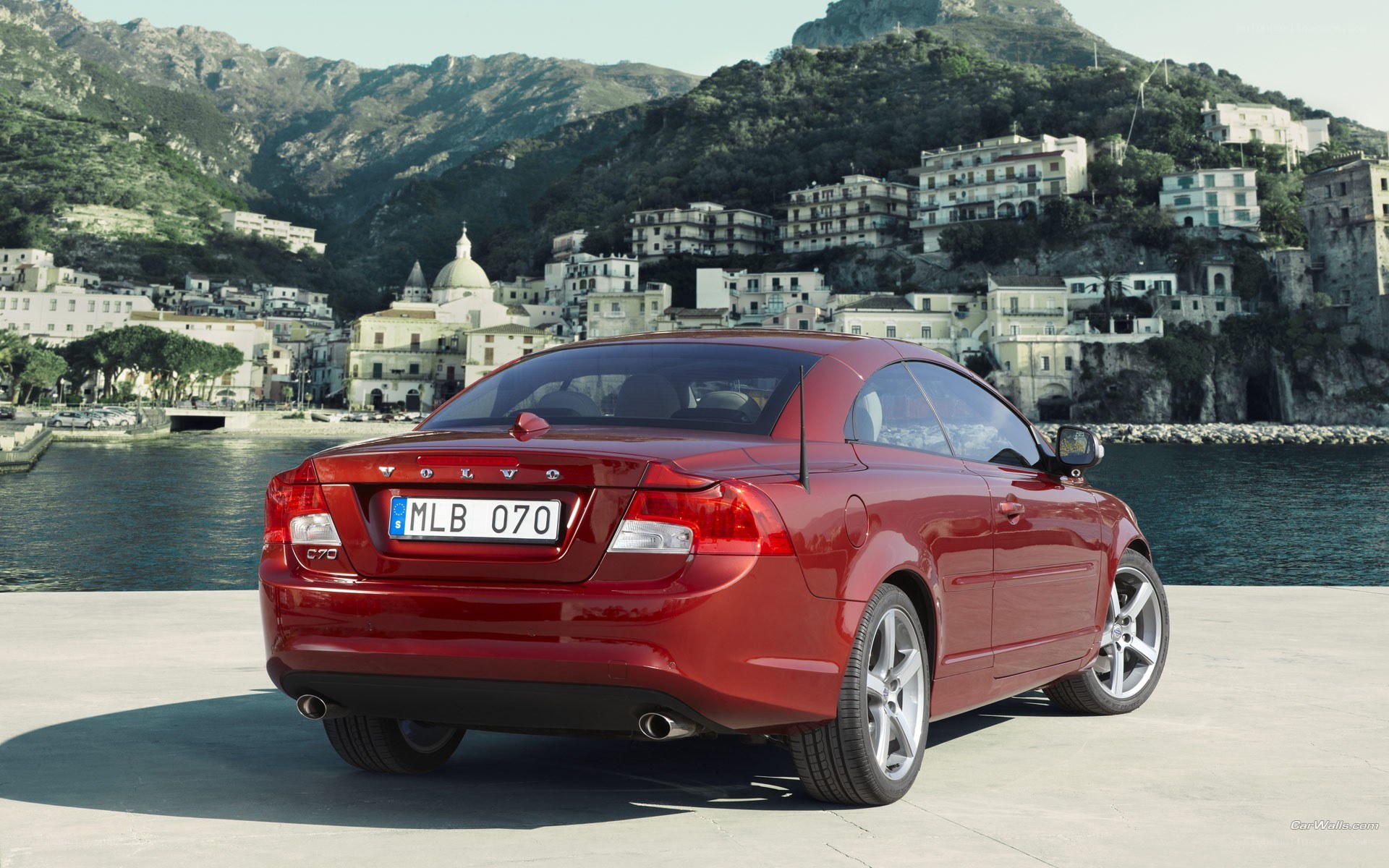 Red Volvo C70 by the coast