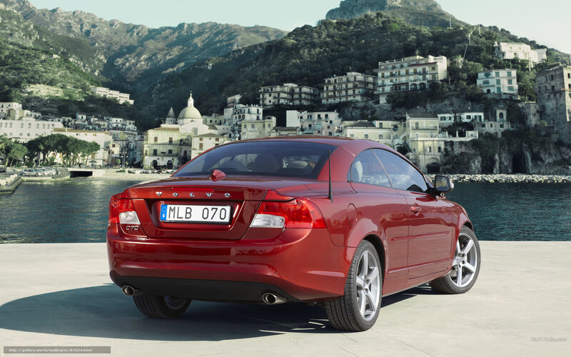 Red Volvo C70 by the coast
