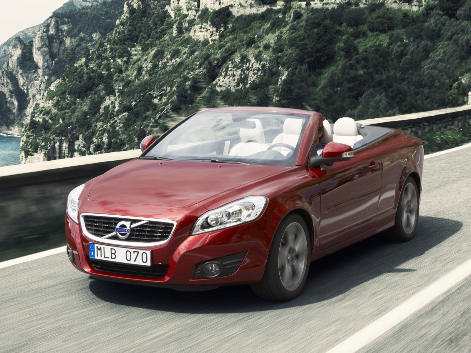Red Volvo C70 convertible driving
