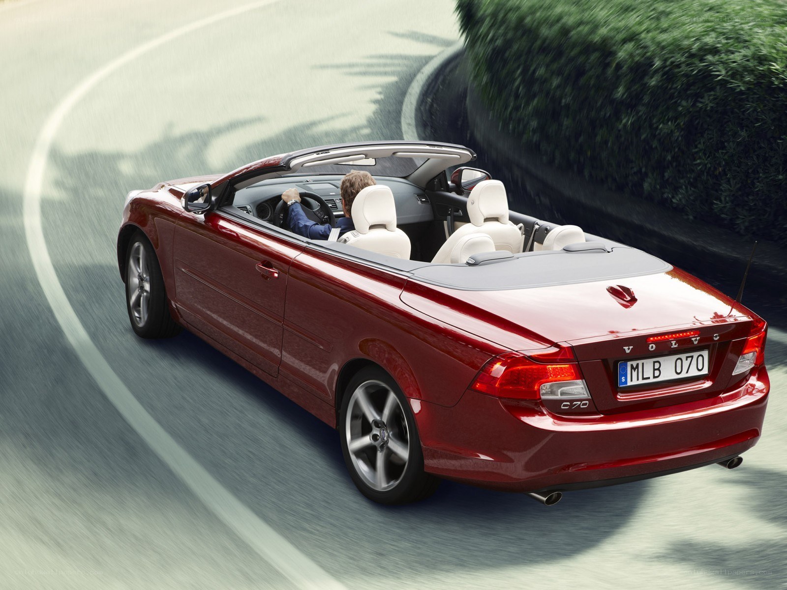 Red Volvo C70 convertible driving