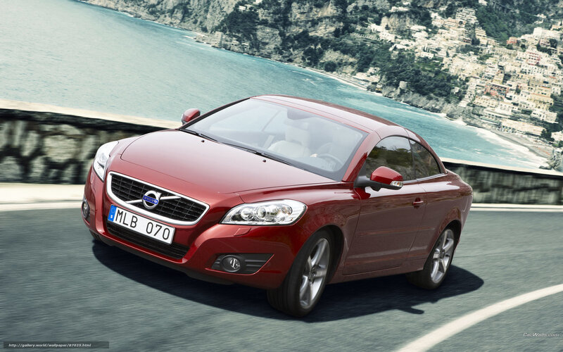 Red Volvo C70 driving on coastal road