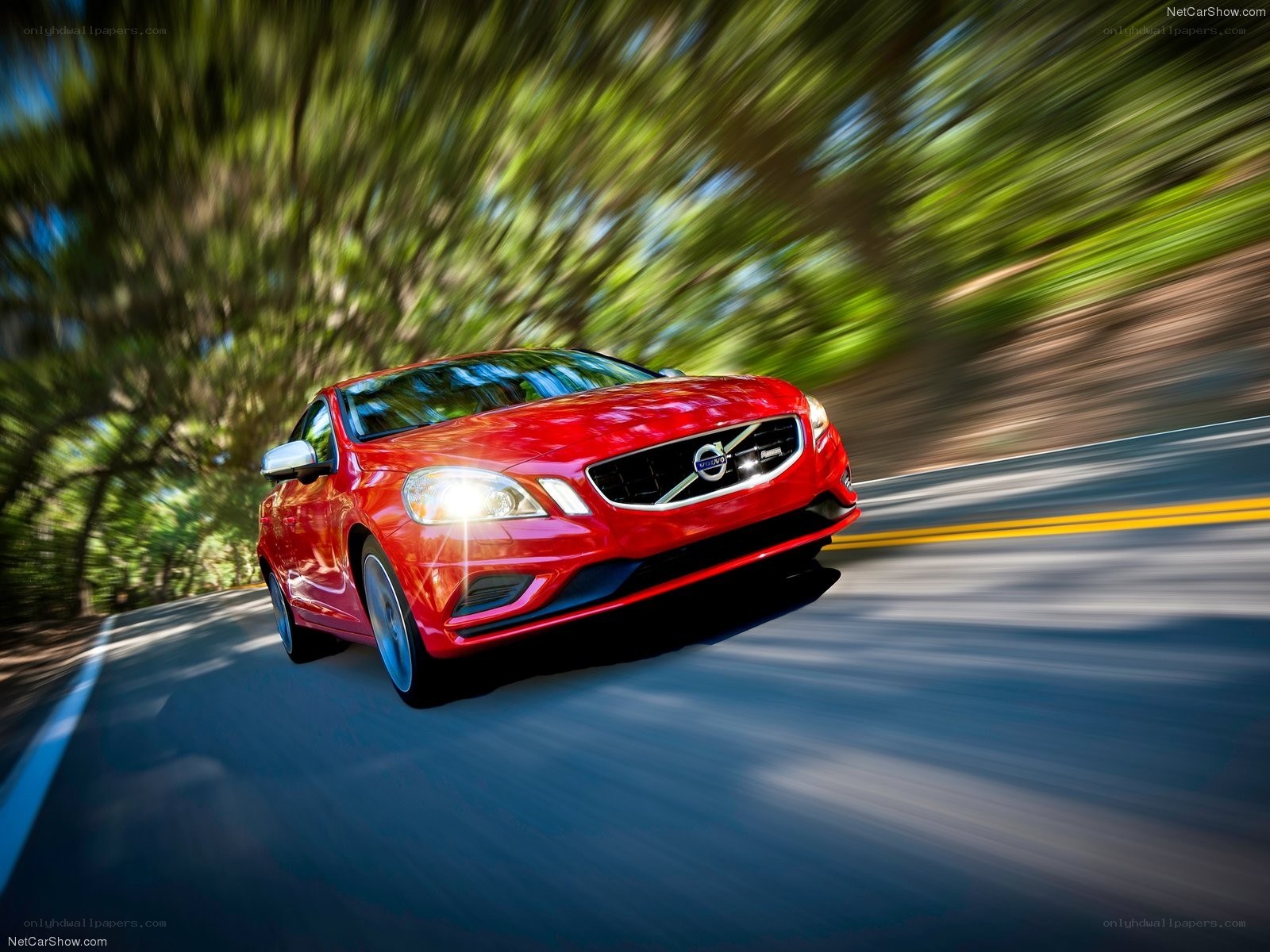 Red Volvo driving on a road