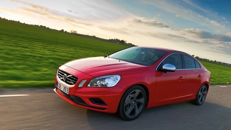 Red Volvo driving on country road