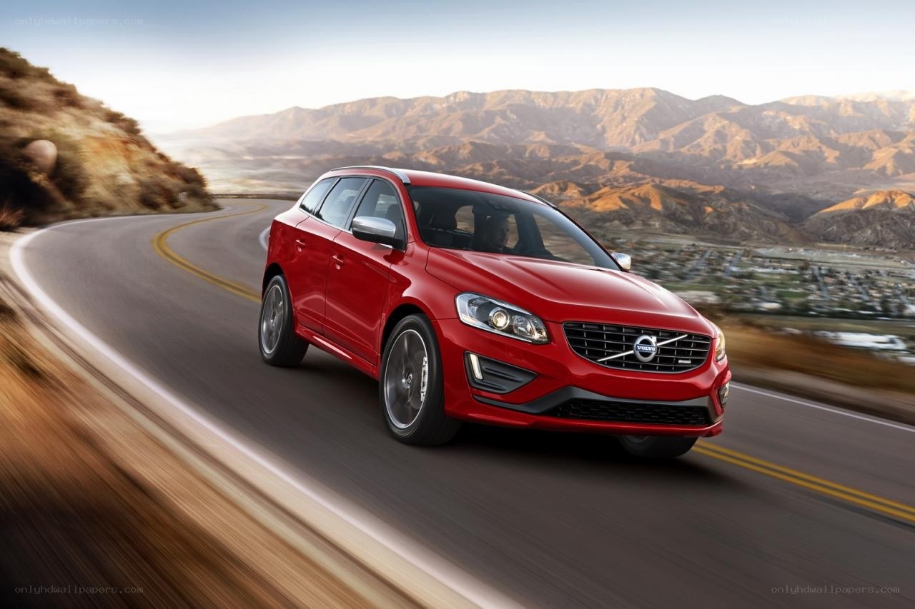 Red Volvo driving on mountain road