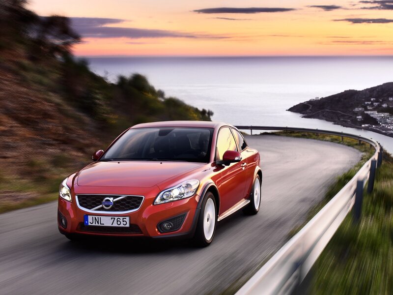 Red Volvo on coastal road
