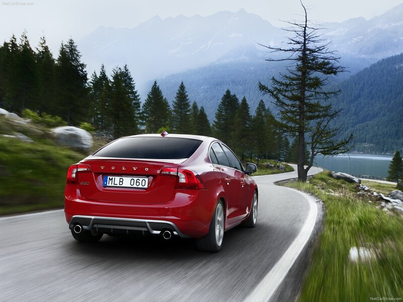 Red Volvo S60 driving on mountain road