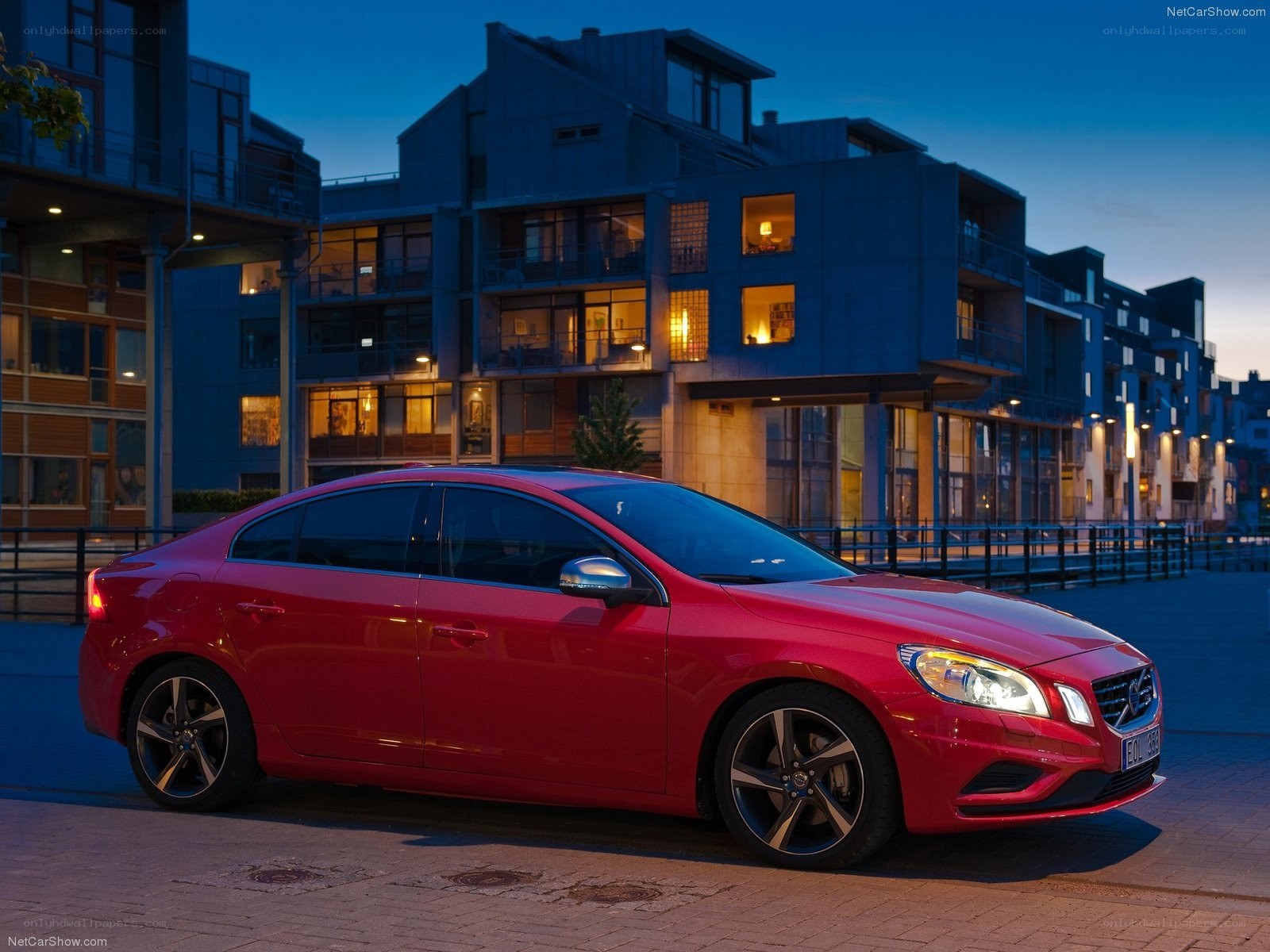 Red Volvo S60 parked at dusk