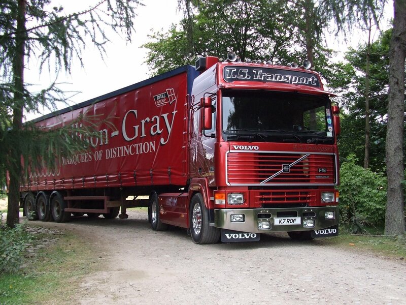 Red Volvo truck on a dirt road
