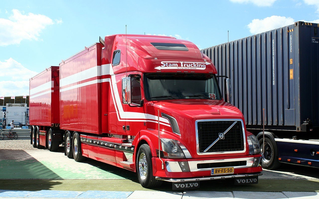 Red Volvo truck with container