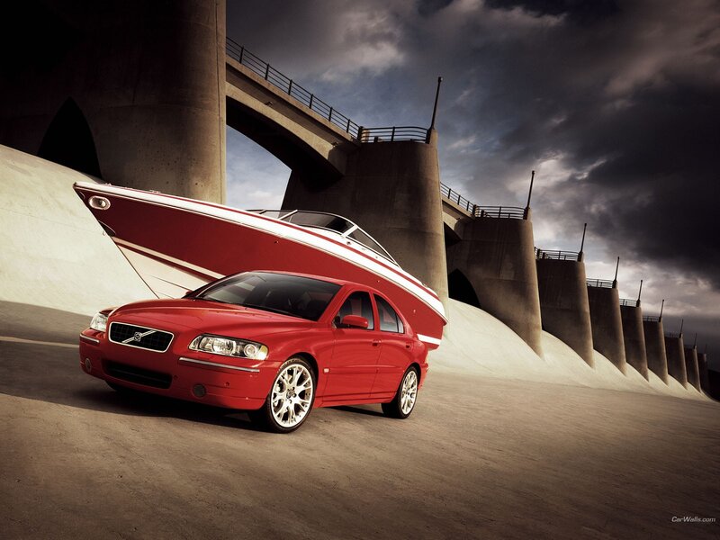 Red Volvo with boat on bridge