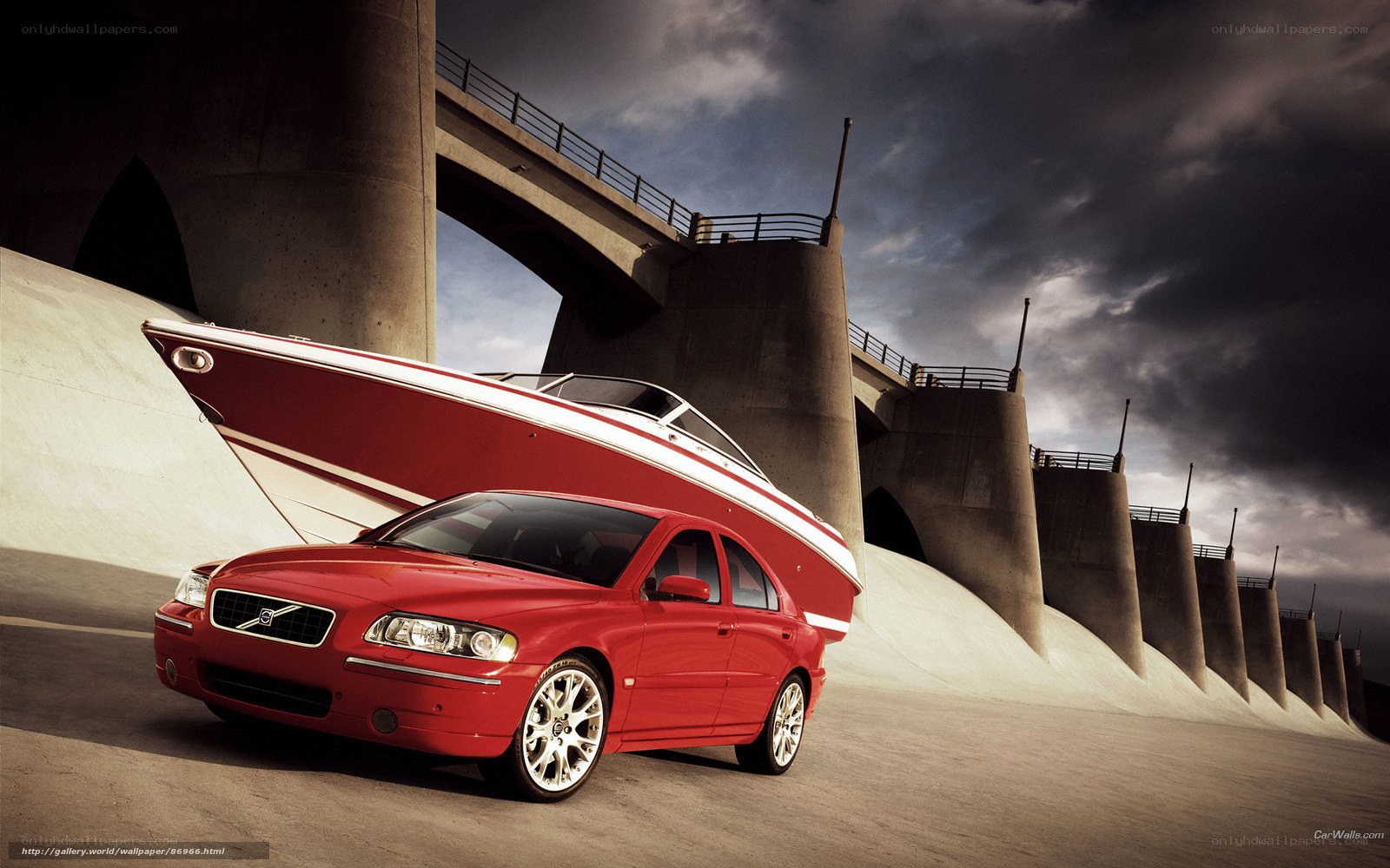 Red Volvo with boat on bridge