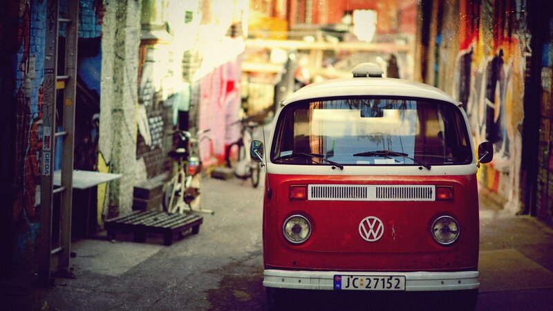 Red VW bus in a graffiti alley