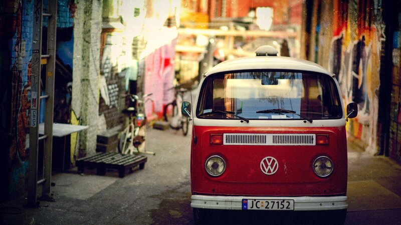Red VW bus in alleyway