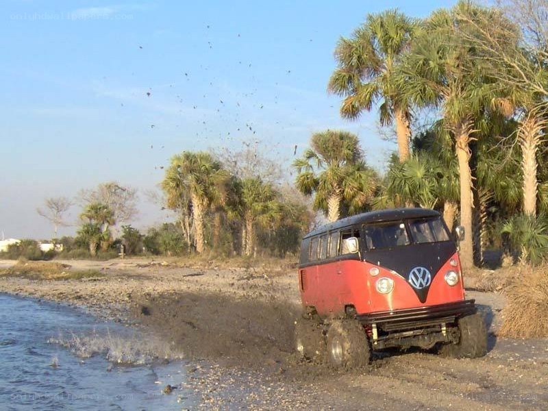 Red VW bus on muddy beach