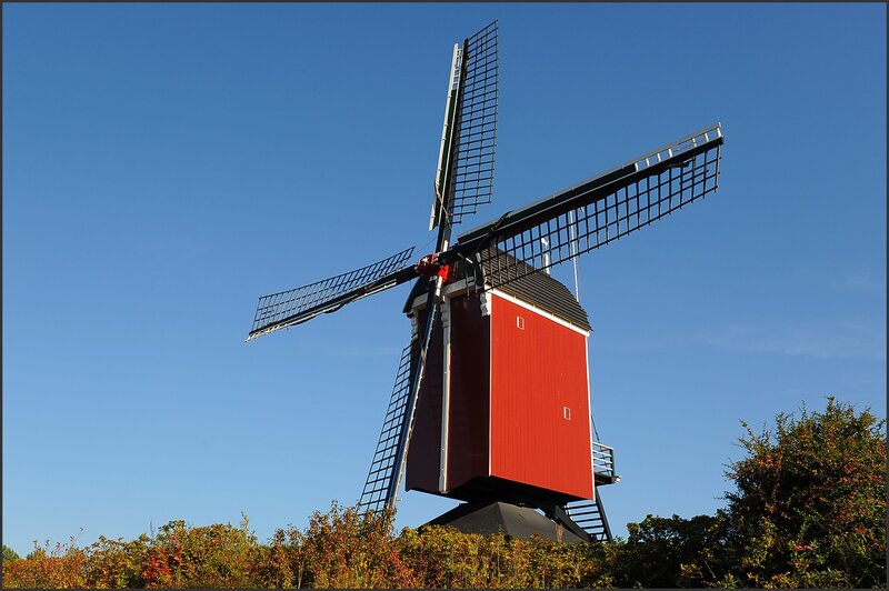 Red windmill against blue sky