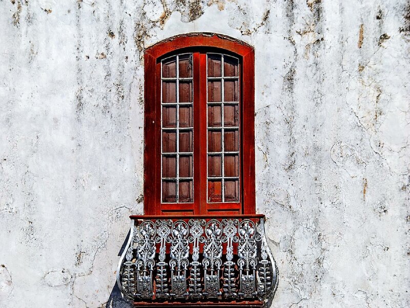 Red window on weathered wall