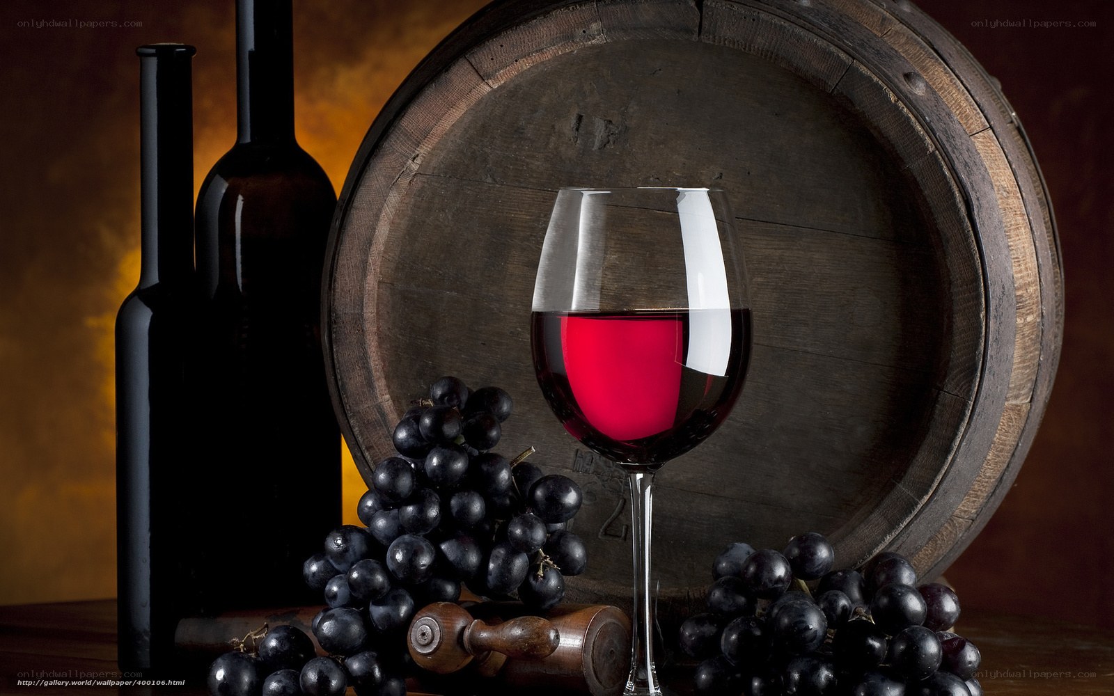 Red wine and grapes on barrel
