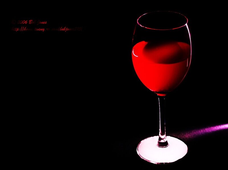 Red wine glass on black background