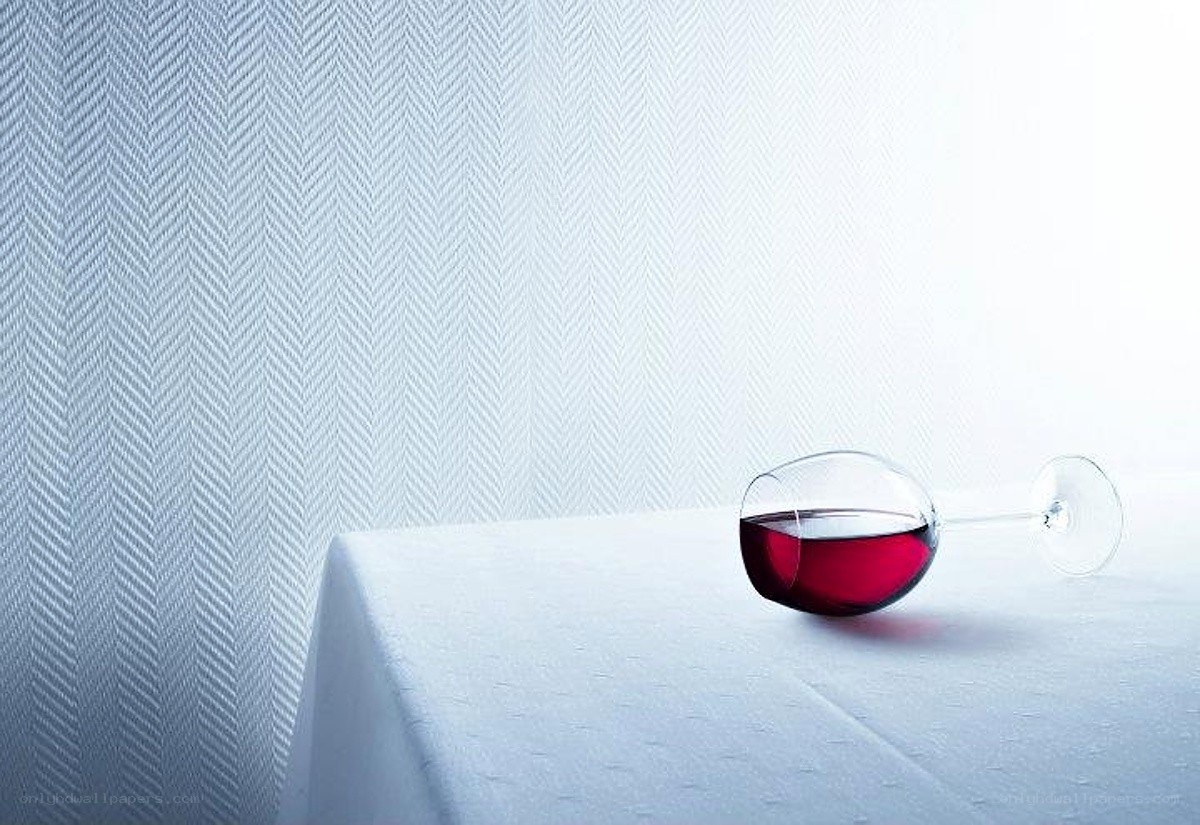 Red wine glass on white table