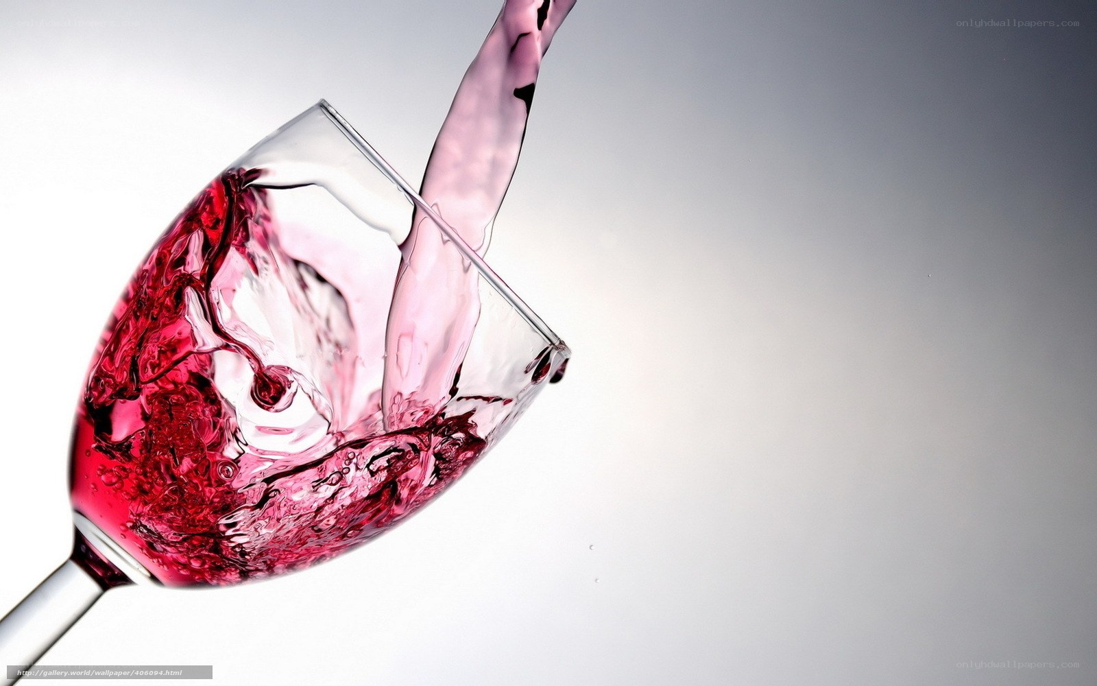 Red wine splashing in glass