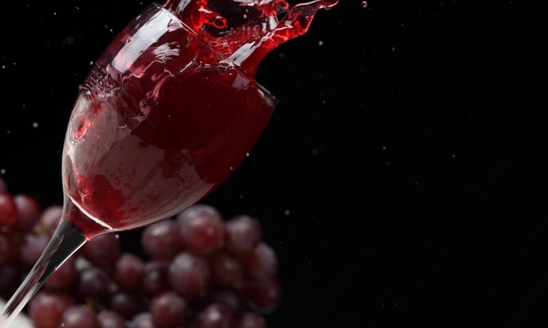 Red wine splashing in glass