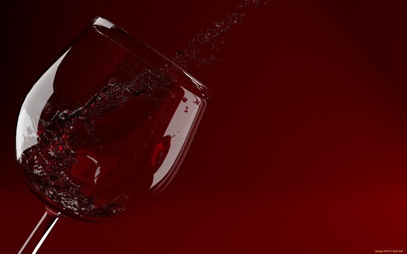 Red wine splashing in glass