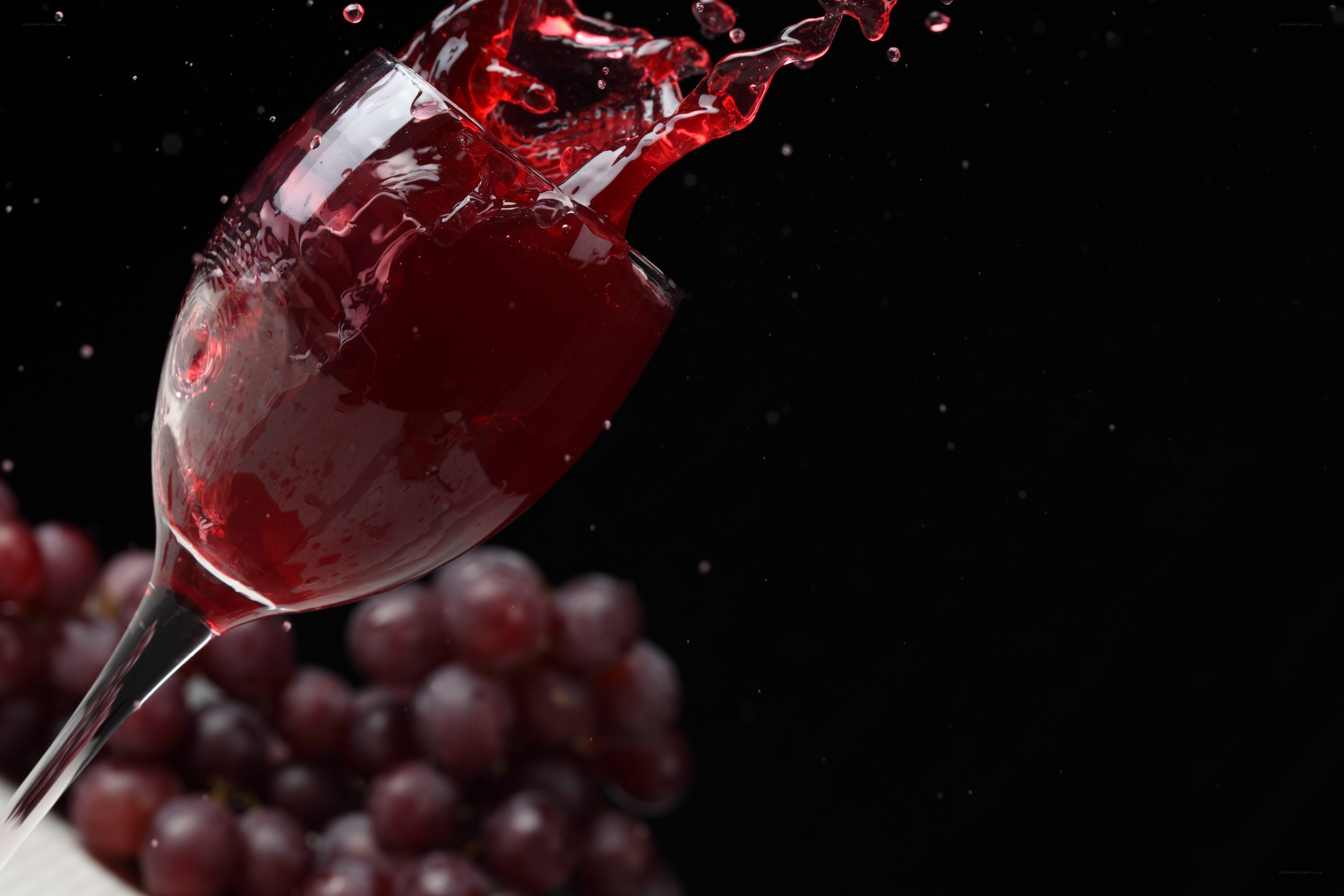Red wine splashing in glass