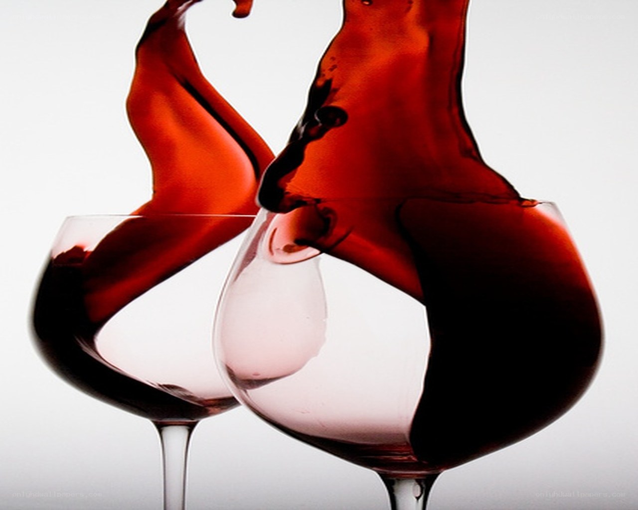 Red wine splashing in glasses
