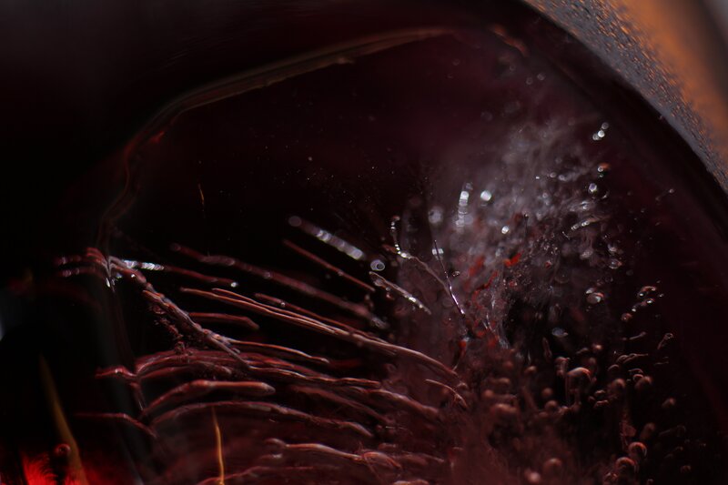 Red wine swirling in glass