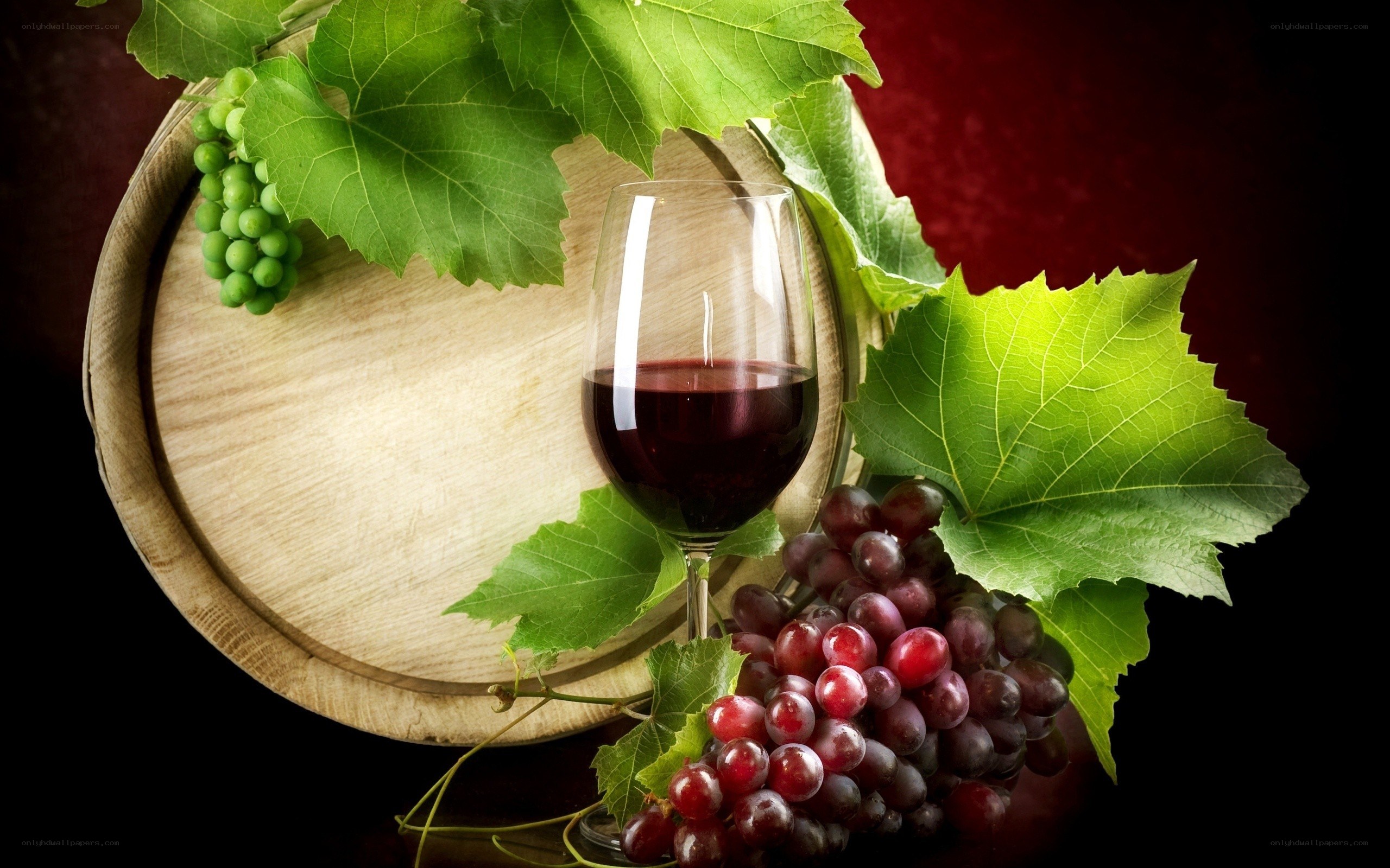 Red wine with grapes and barrel