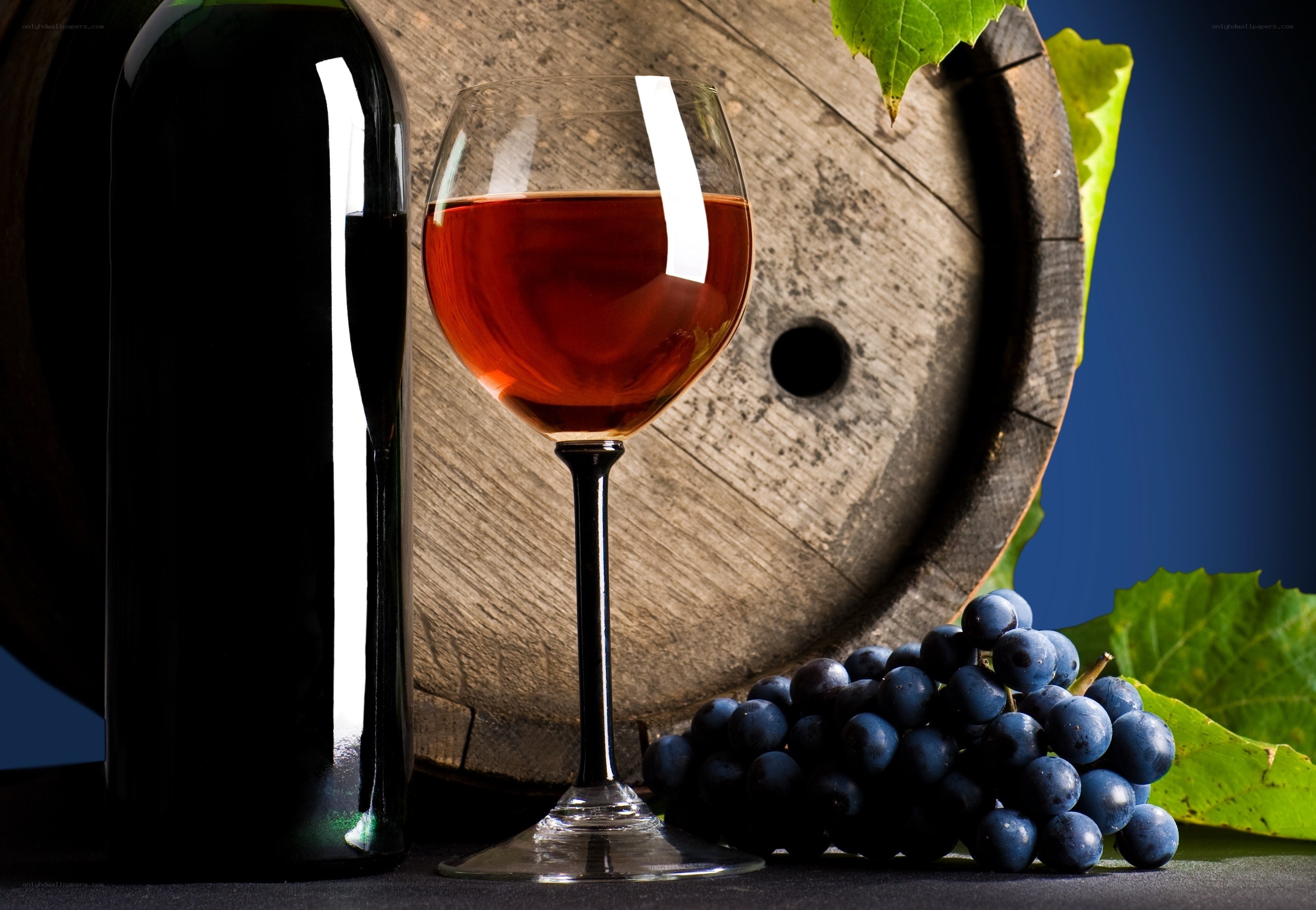 Red wine with grapes and barrel