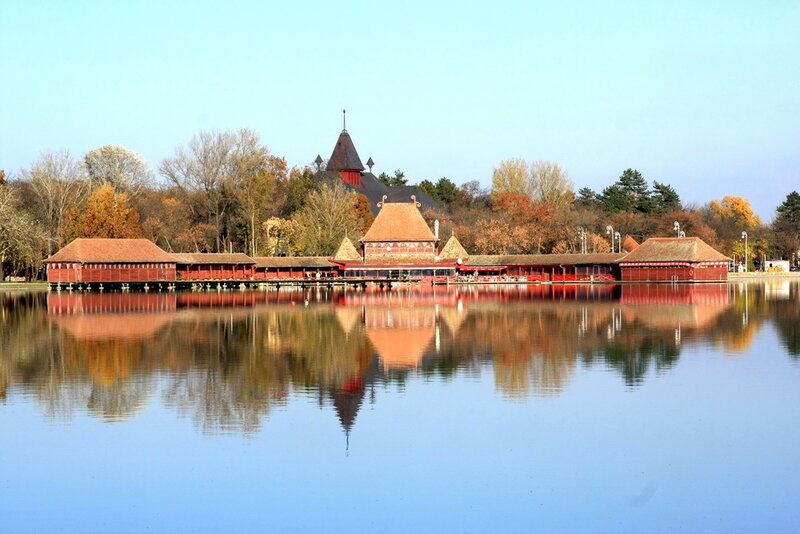 Red Wooden Buildings on Lake
