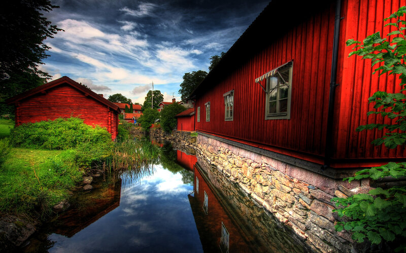 Red wooden houses by a canal