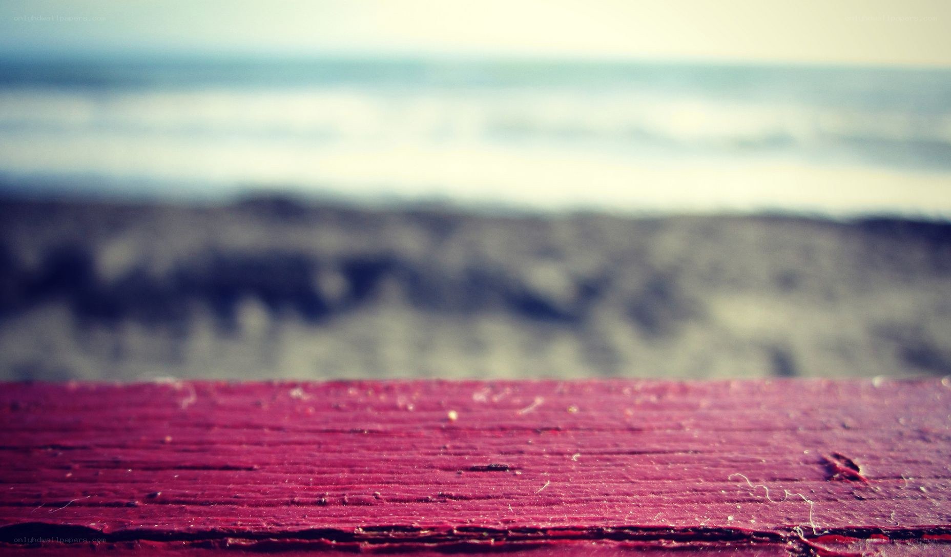 red wooden surface at the beach