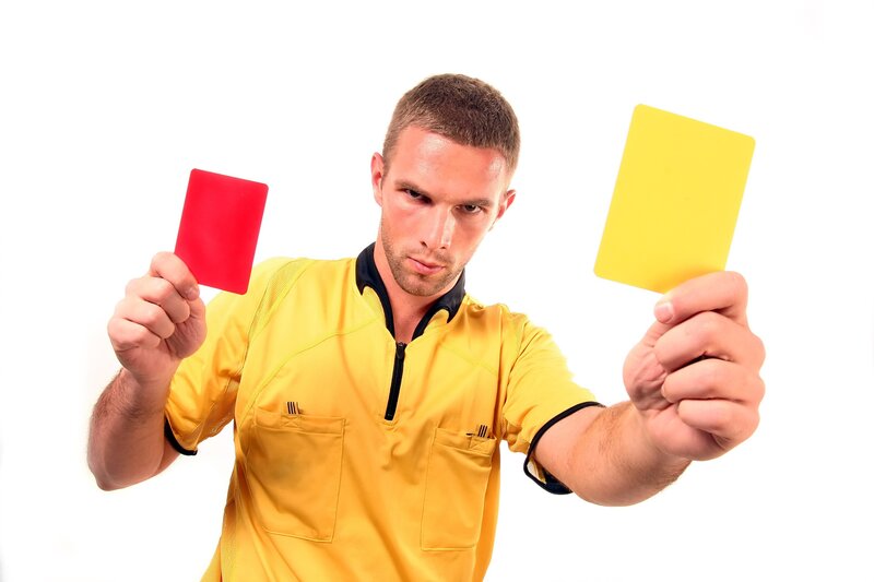 Referee Holding Cards — Yellow