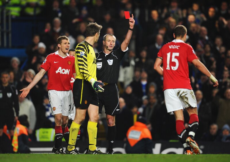 Referee shows red card in football match