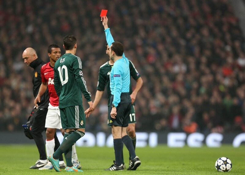 Referee shows red card in soccer match