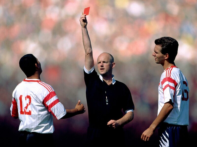 Referee shows red card to player