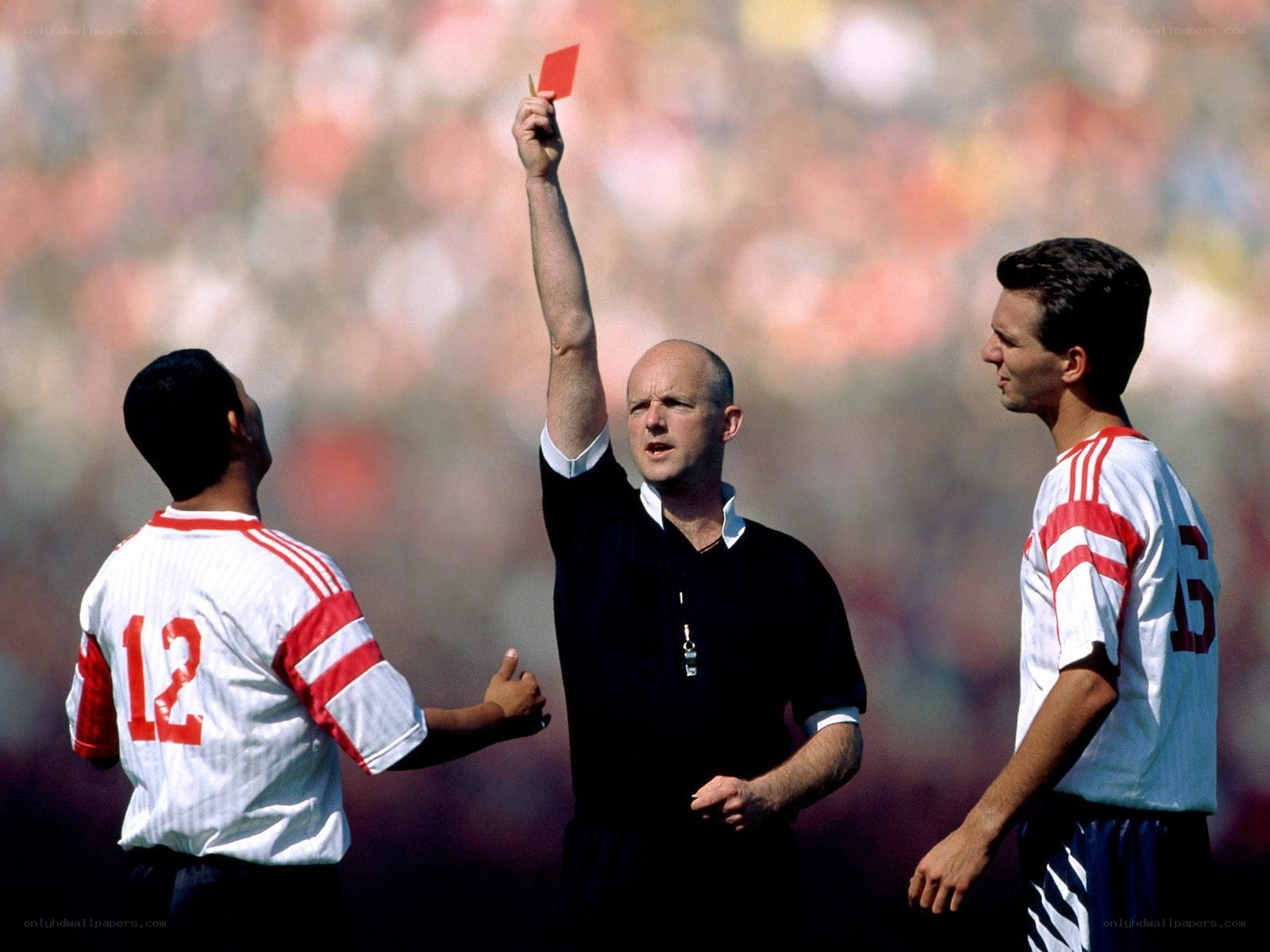 Referee shows red card to player