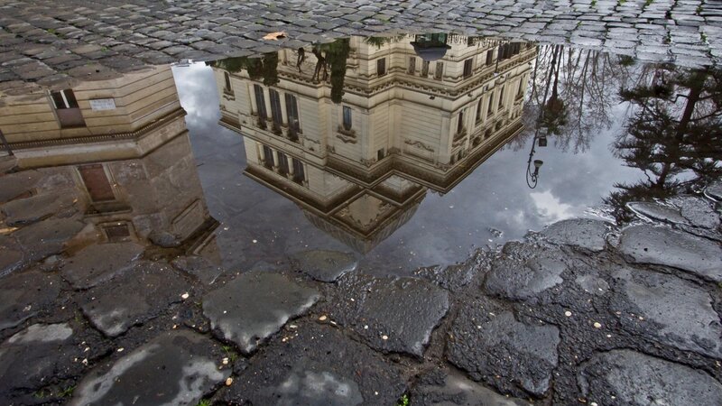 Reflection of Building in Puddle — Gray