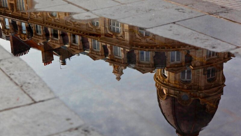reflection of building in puddle