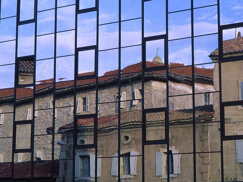 Reflection of old buildings in glass
